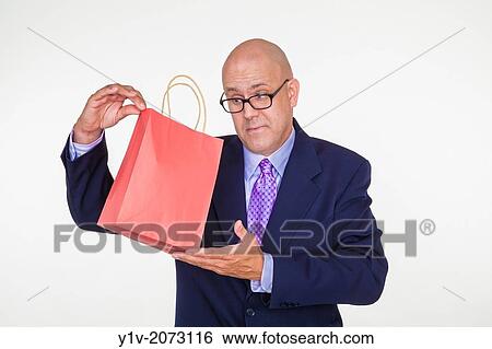 Stock Photograph - Middle-age bald man holding a paper bag.. Fotosearch