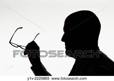Stock Photography - Middle-age bald man holding his glasses.. Fotosearch