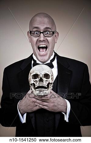 Middle-age bald man, in a tuxedo, holding a skull View Large Photo Image Stock Image - Middle-age bald man, in a tuxedo, holding a skull. Fotosearch