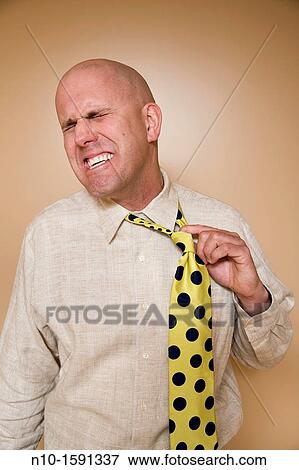 Middle-age bald man pulling on his tie View Large Photo Image Stock Photo - Middle-age bald man pulling on his tie. Fotosearch