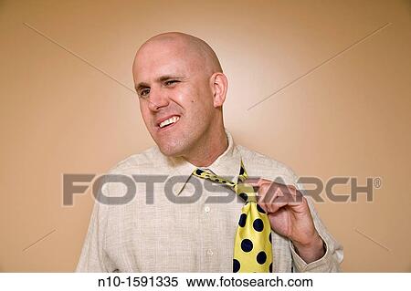 Middle-age bald man pulling on his tie View Large Photo Image Stock Photography - Middle-age bald man pulling on his tie. Fotosearch