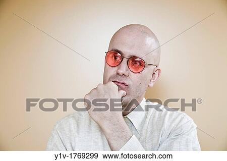 Stock Photo - Middle-age bald man wearing glasses. Fotosearch