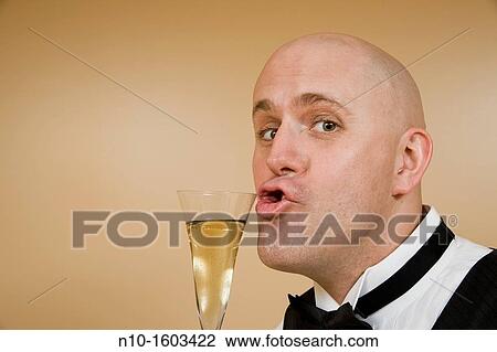 Middle-age bald man with a glass of champagne View Large Photo Image Stock Image - Middle-age bald man with a glass of champagne. Fotosearch