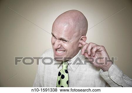 Middle-age bald man with his finger in his ear View Large Photo Image Stock Photo - Middle-age bald man with his finger in his ear. Fotosearch