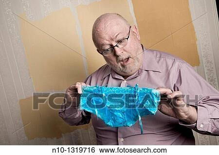 Middle-age balding man holding a pair of lady's panties View Large Photo Image Stock Photograph - Middle-age balding man holding a pair of lady's panties. Fotosearch