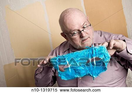 Middle-age balding man holding a pair of lady's panties View Large Photo Image Stock Photography - Middle-age balding man holding a pair of lady's panties. Fotosearch