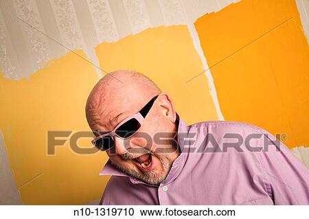 Stock Image - Middle-age balding man wearing sunglasses. Fotosearch