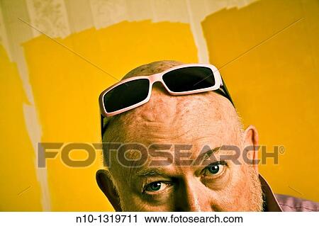 Stock Image - Middle-age balding man with sunglasses on his head. Fotosearch