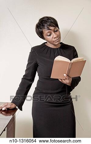 Middle-age black woman reading a book, View Large Photo Image Picture - Middle-age black woman reading a book,. Fotosearch