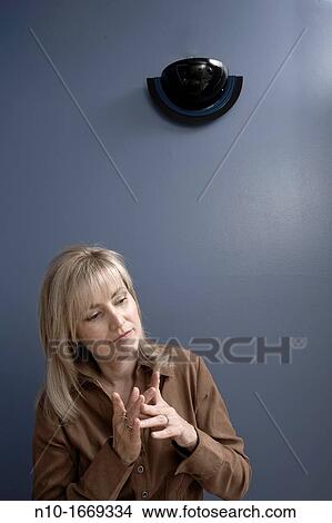 Middle-age blond woman beneath a wall sconce View Large Photo Image Picture - Middle-age blond woman beneath a wall sconce. Fotosearch