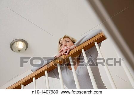 Middle-age blond woman on the landing in her house View Large Photo Image Stock Image - Middle-age blond woman on the landing in her house. Fotosearch