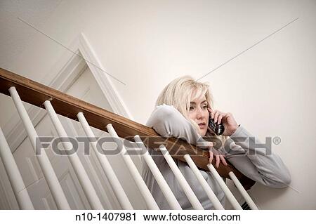 Middle-age blond woman talking on her telephone View Large Photo Image Stock Image - Middle-age blond woman talking on her telephone. Fotosearch