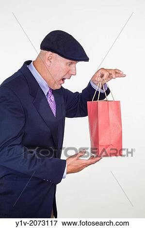 Stock Photo - Middle-age man holding a paper bag.. Fotosearch