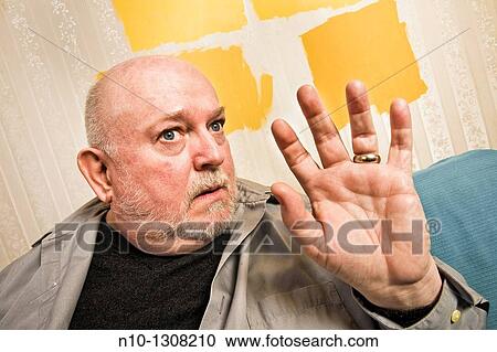 Middle-age man holding up his hand View Large Photo Image Stock Image - Middle-age man holding up his hand. Fotosearch