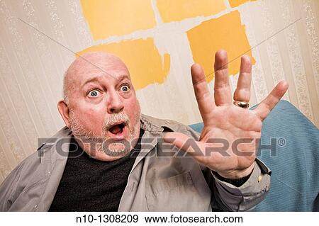 Middle-age man holding up his hand View Large Photo Image Stock Photo - Middle-age man holding up his hand. Fotosearch