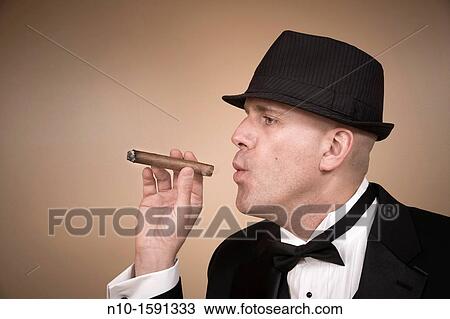 Middle-age man in a tuxedo, with a hat and cigar View Large Photo Image Stock Image - Middle-age man in a tuxedo, with a hat and cigar. Fotosearch