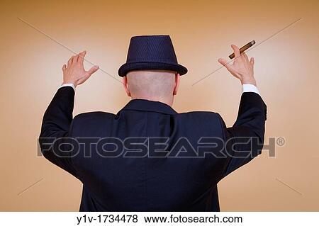 Middle-age man in a tuxedo, with a hat and cigar View Large Photo Image Stock Photo - Middle-age man in a tuxedo, with a hat and cigar. Fotosearch