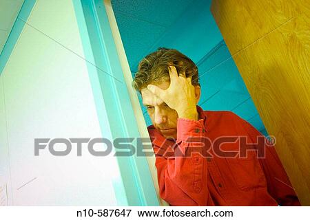 Middle-age man peering out his office door. View Large Photo Image Stock Photo - Middle-age man peering out his office door.. Fotosearch