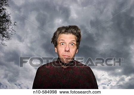 Middle-age man posing in front of a cloudy sky. View Large Photo Image Stock Photo - Middle-age man posing in front of a cloudy sky.. Fotosearch