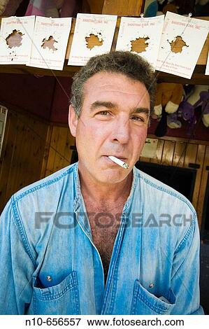 Middle-age man smoking a cigarette. View Large Photo Image Stock Photo - Middle-age man smoking a cigarette.. Fotosearch