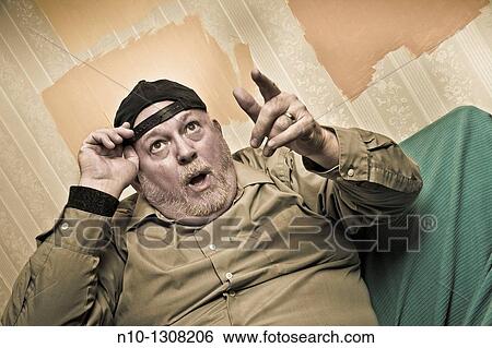 Middle-age man wearing a baseball cap View Large Photo Image Stock Photograph - Middle-age man wearing a baseball cap. Fotosearch