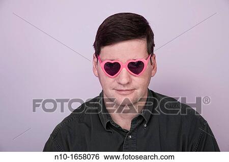 Middle-age man wearing heart shaped sunglasses View Large Photo Image Stock Photograph - Middle-age man wearing heart shaped sunglasses. Fotosearch