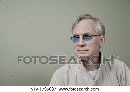 Stock Photo - Middle-age man wearing sunglasses. Fotosearch