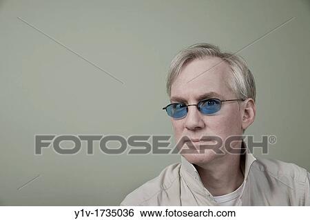 Stock Photograph - Middle-age man wearing sunglasses. Fotosearch
