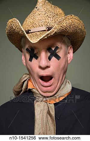 Stock Photograph - Middle-age man with black tape covering his eyes. Fotosearch