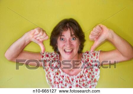 Middle age woman giving a? two thumbs down?. View Large Photo Image Stock Photo - Middle age woman giving a? two thumbs down?.. Fotosearch