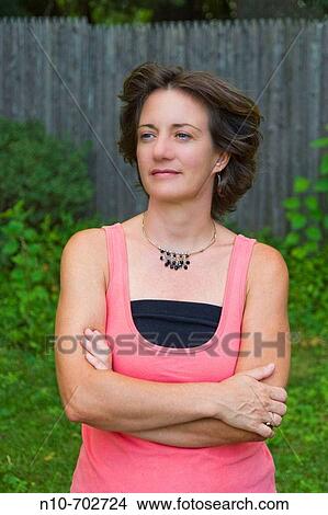 Middle age woman posing for the camera. View Large Photo Image Picture - Middle age woman posing for the camera.. Fotosearch