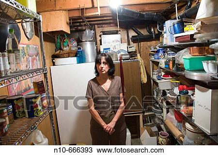 Middle-age woman posing in the basement storage room of her house. View Large Photo Image Stock Image - Middle-age woman posing in the basement storage room of her house.. Fotosearch