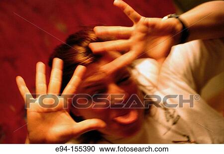 Middle age woman sticking tongue out and holding hands up to the camera View Large Photo Image Stock Image - Middle age woman sticking tongue out and holding hands up to the camera. Fotosearch