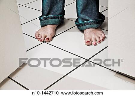 Middle-age woman's feet near double doors in kitchen View Large Photo Image Stock Image - Middle-age woman's feet near double doors in kitchen. Fotosearch