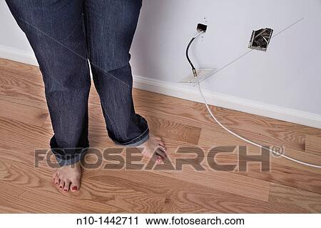Middle-age woman's legs near electrical connections View Large Photo Image Stock Image - Middle-age woman's legs near electrical connections. Fotosearch
