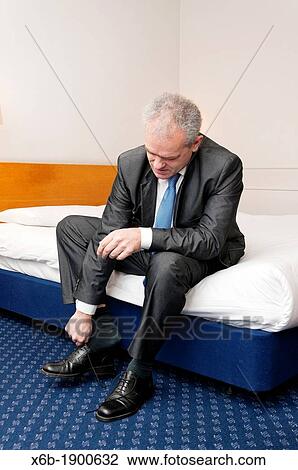 Middle aged business man dressing in a hotel room View Large Photo Image Stock Image - Middle aged business man dressing in a hotel room. Fotosearch