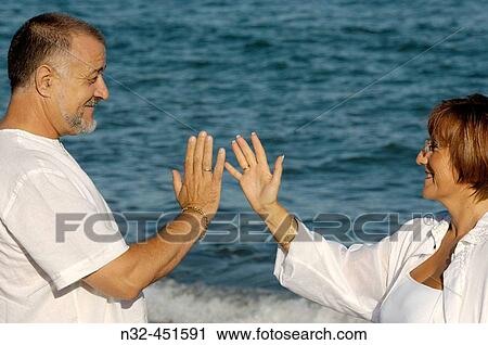 Stock Image - Middle-aged couple on the beach. Fotosearch
