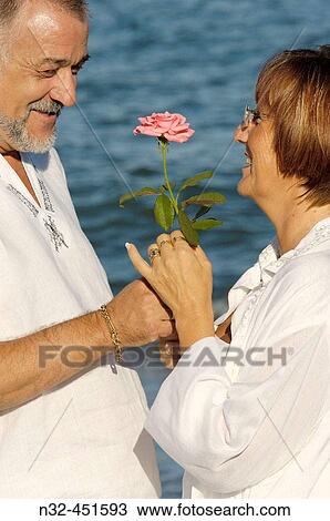 Stock Image - Middle-aged couple on the beach. Fotosearch