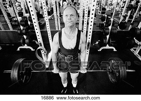 Middle aged man deadlifting 300 lbs barbell in gym View Large Photo Image Stock Photograph - Middle aged man deadlifting 300 lbs barbell in gym. Fotosearch