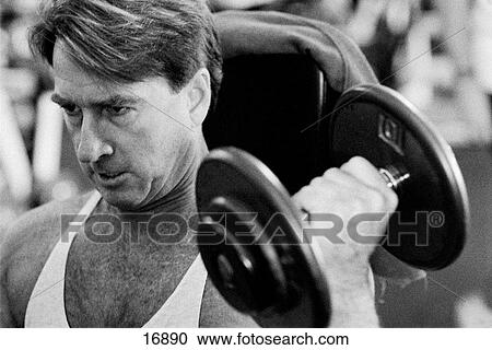 Middle aged man lifting hand weight View Large Photo Image Stock Image - Middle aged man lifting hand weight. Fotosearch
