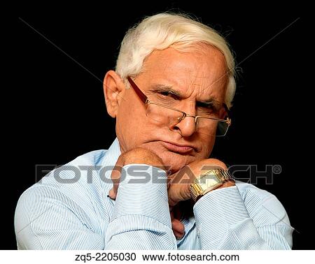 Stock Image - Middle aged man looking unconvinced. Pune, India.. Fotosearch