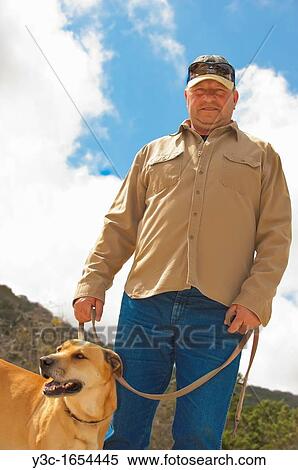 Middle aged man taking his dog on the leash for a walk View Large Photo Image Stock Photography - Middle aged man taking his dog on the leash for a walk. Fotosearch