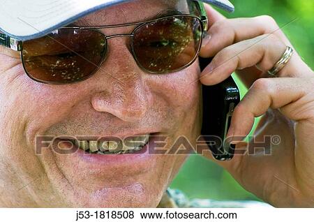Middle aged man talking on cell phone View Large Photo Image Stock Photo - Middle aged man talking on cell phone. Fotosearch