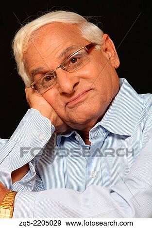 Stock Photo - Middle aged man thinking, Pune, India.. Fotosearch