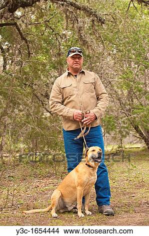 Middle aged man with dog on a leash View Large Photo Image Picture - Middle aged man with dog on a leash. Fotosearch