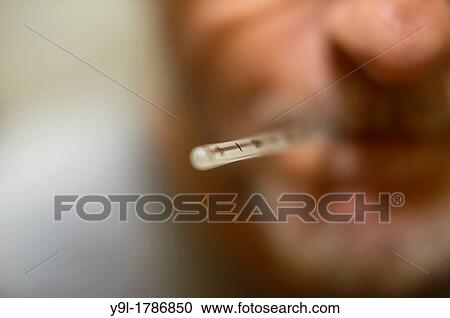Middle-aged man with oral thermometer in his mouth View Large Photo Image Stock Image - Middle-aged man with oral thermometer in his mouth. Fotosearch