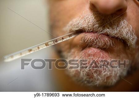 Middle-aged man with oral thermometer in his mouth View Large Photo Image Stock Image - Middle-aged man with oral thermometer in his mouth. Fotosearch