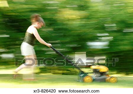 Middle-aged woman mowing lawn in late afternoon sunlight Motion blurred View Large Photo Image Stock Image - Middle-aged woman mowing lawn in late afternoon sunlight Motion blurred. Fotosearch