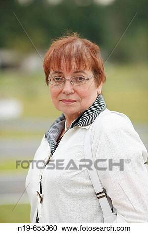 Stock Image - Middle aged woman outdoors. Fotosearch