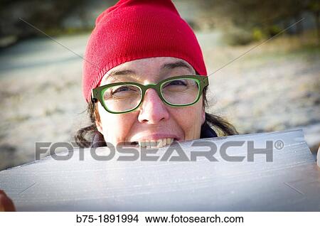 Picture - middle-aged woman playing with ice. Fotosearch